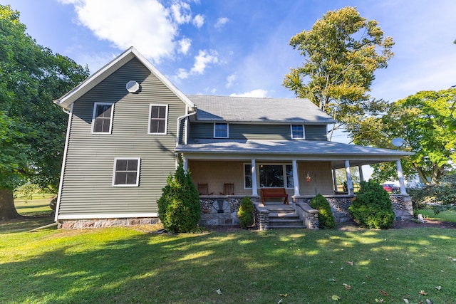 view of front facade with a front lawn and covered porch