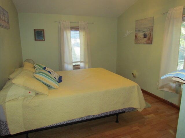 bedroom featuring lofted ceiling and wood-type flooring