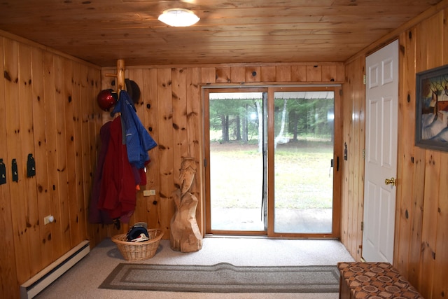 doorway with wood walls, carpet floors, a baseboard radiator, and wooden ceiling