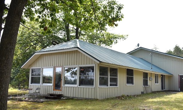 back of house with a lawn