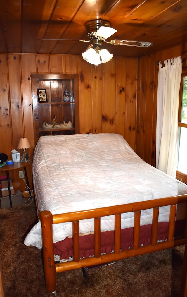 bedroom with carpet, wood walls, wooden ceiling, and ceiling fan