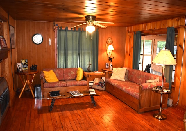 living room featuring hardwood / wood-style floors, wood ceiling, and wooden walls