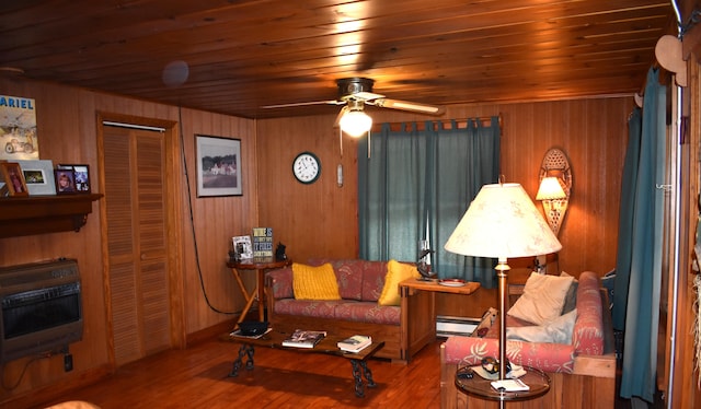 living room featuring ceiling fan, wooden ceiling, wooden walls, and hardwood / wood-style floors