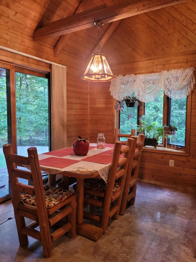 dining room featuring vaulted ceiling with beams, an inviting chandelier, tile patterned floors, wooden ceiling, and wooden walls