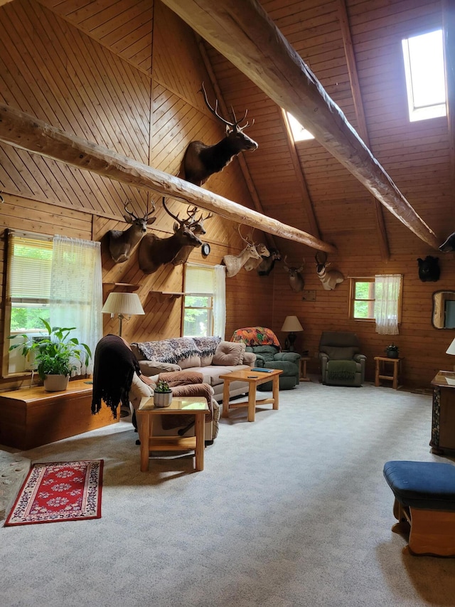 living room featuring wood walls, carpet, and a healthy amount of sunlight