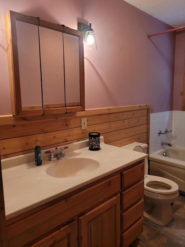 bathroom featuring a textured ceiling, toilet, vanity, and tile patterned floors