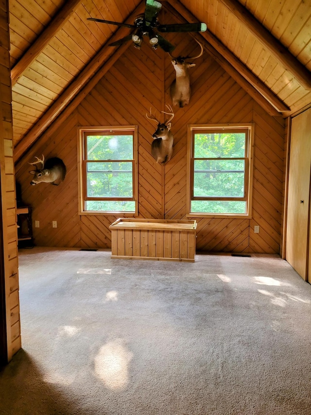 unfurnished living room with carpet floors, wood ceiling, and wooden walls