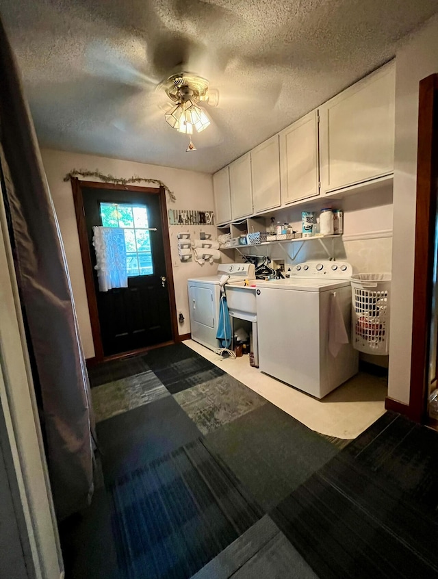 clothes washing area featuring independent washer and dryer, ceiling fan, a textured ceiling, and cabinets