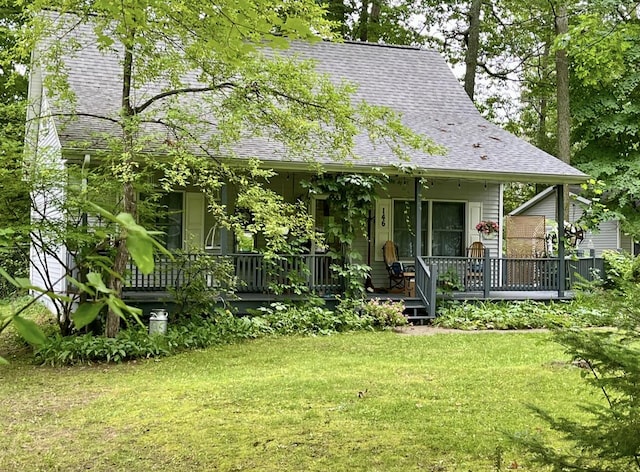 rear view of property with a porch and a lawn