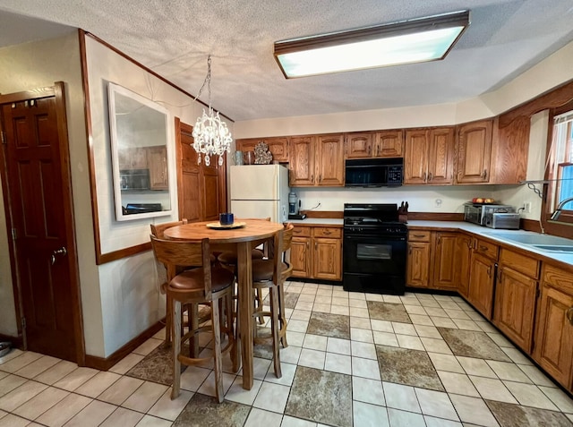 kitchen featuring hanging light fixtures, a notable chandelier, a textured ceiling, black appliances, and light tile patterned flooring