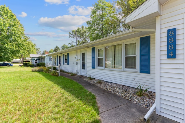 view of side of home featuring a lawn