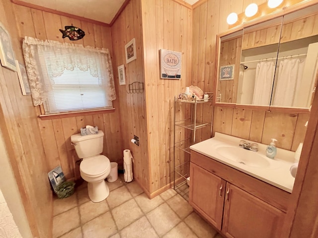 bathroom with vanity, crown molding, toilet, curtained shower, and wood walls