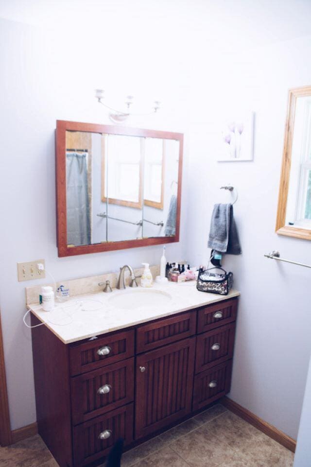 bathroom with tile patterned flooring and vanity