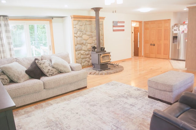 living room featuring hardwood / wood-style floors and a wood stove