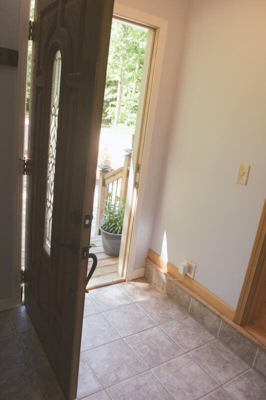 entryway with light tile patterned floors