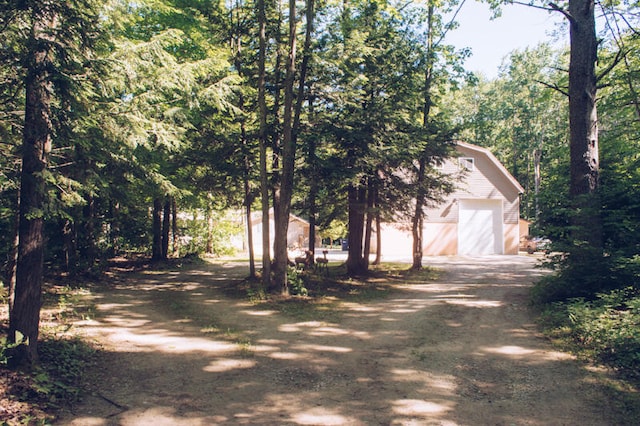 exterior space with a garage and an outbuilding