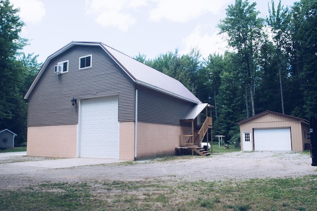 view of side of home with an outdoor structure and a garage