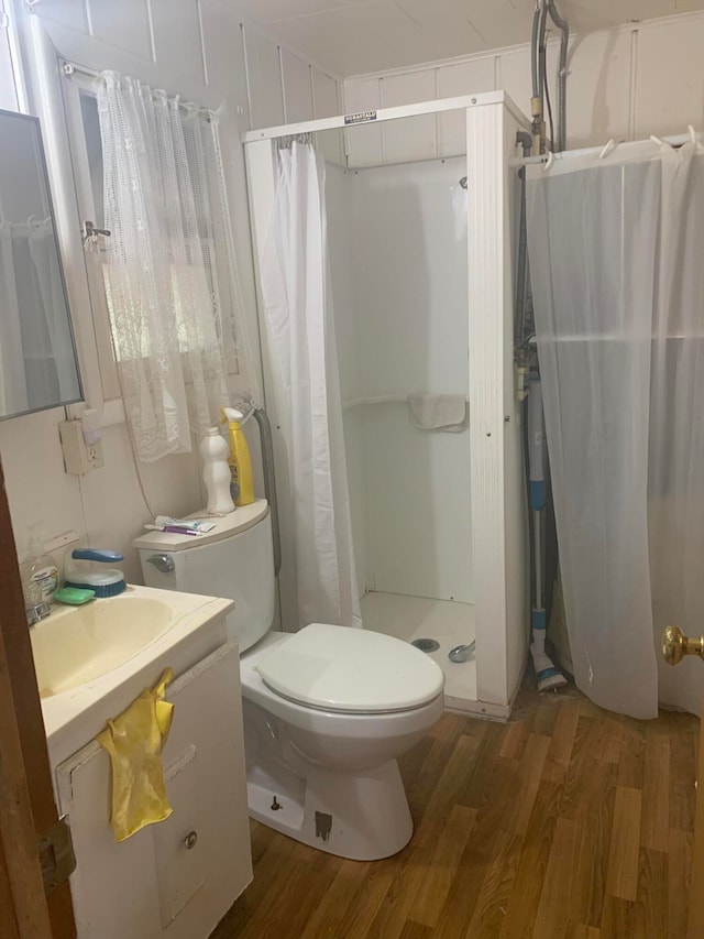 bathroom featuring vanity, hardwood / wood-style floors, toilet, and a shower with shower curtain