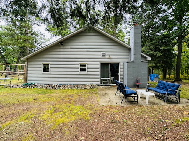 back of property with an outdoor hangout area and a patio