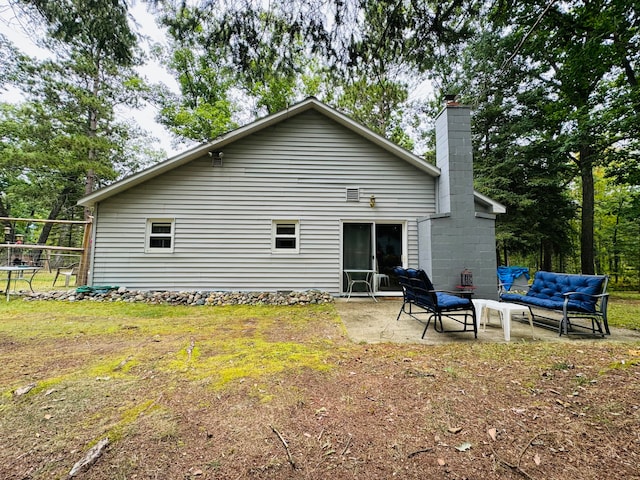 rear view of property featuring an outdoor hangout area and a patio area