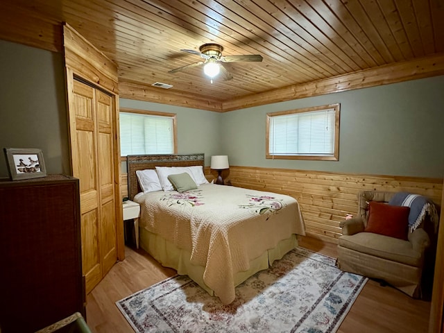 bedroom with multiple windows, ceiling fan, and light hardwood / wood-style flooring