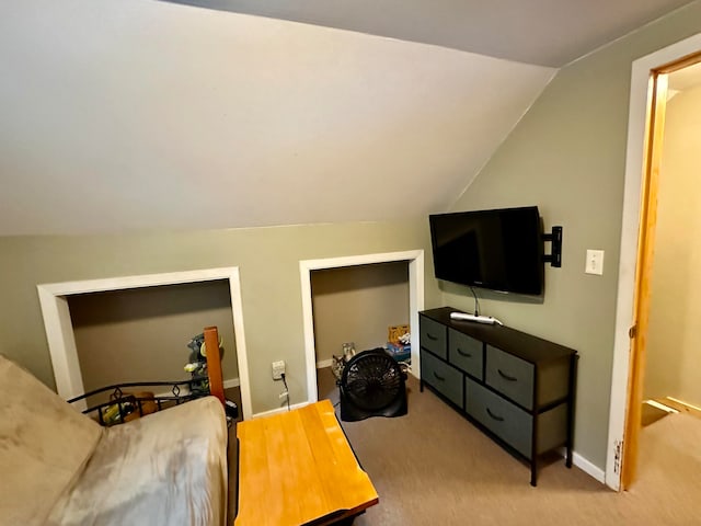 carpeted bedroom with vaulted ceiling