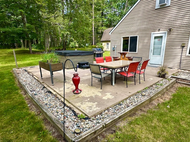 view of patio / terrace featuring a grill and a hot tub