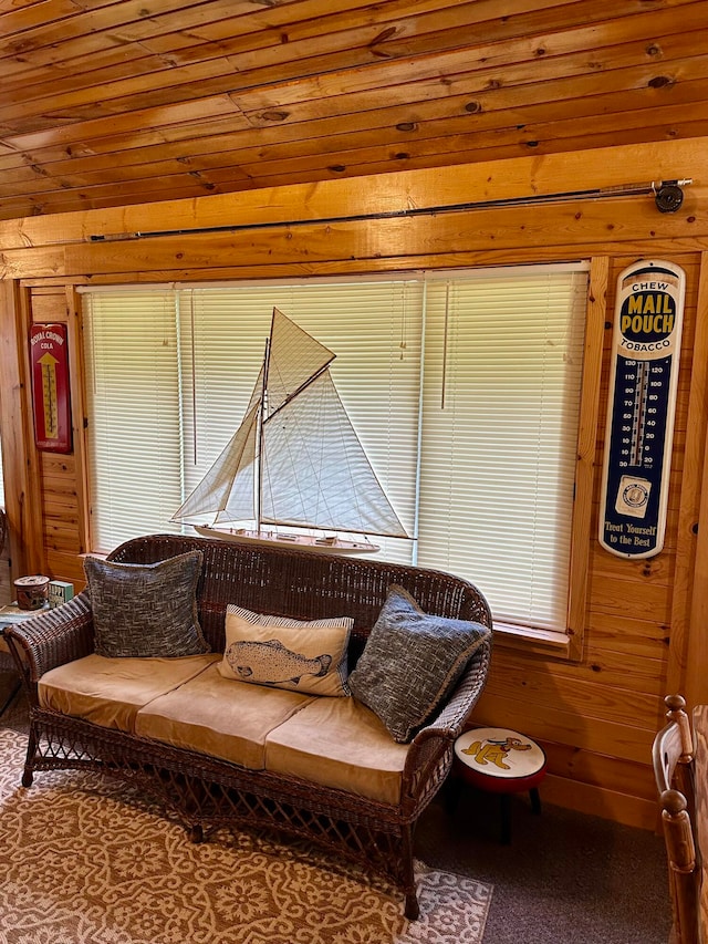 living room featuring wood walls, carpet floors, and wooden ceiling