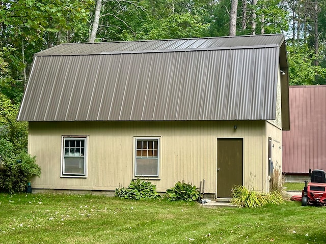 view of outbuilding with a yard