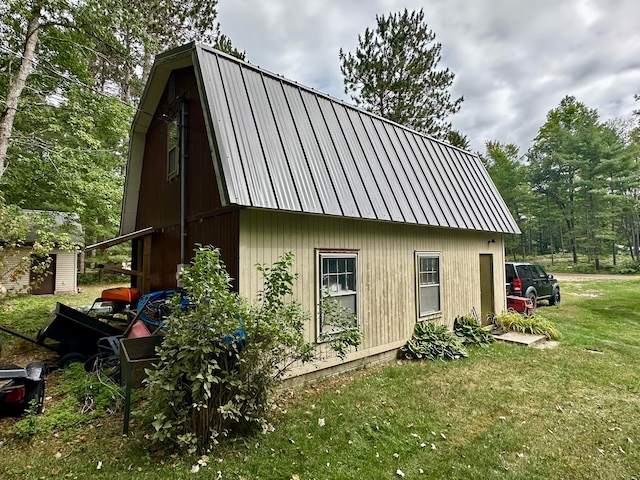 exterior space featuring a lawn and an outbuilding