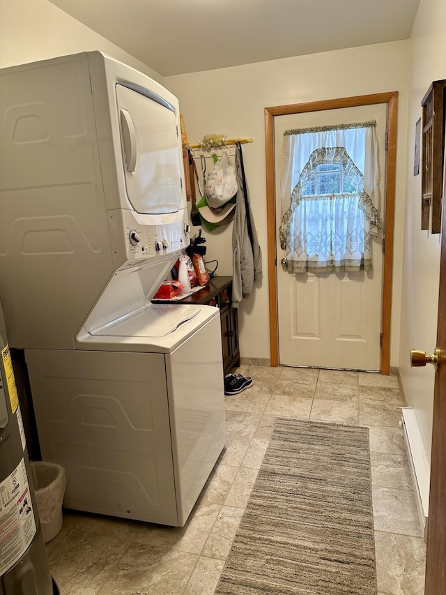 washroom with stacked washer and dryer and laundry area