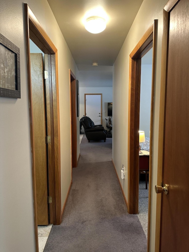 hall with carpet and baseboards