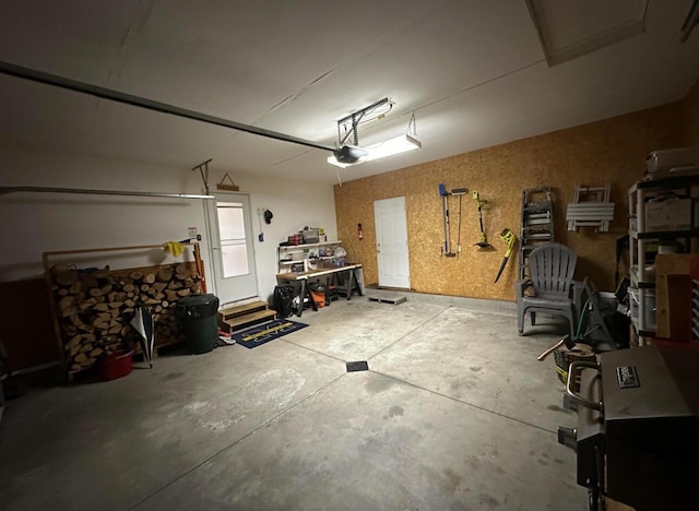 garage with a workshop area and a garage door opener