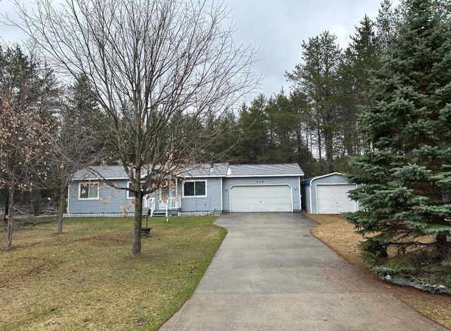 ranch-style house with a garage and a front yard