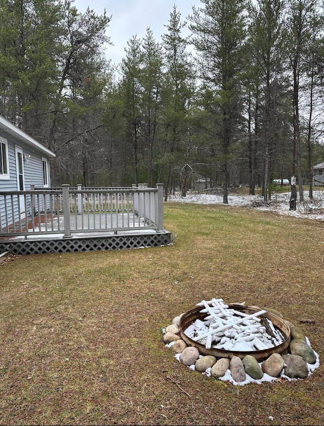 view of yard featuring an outdoor fire pit and a deck