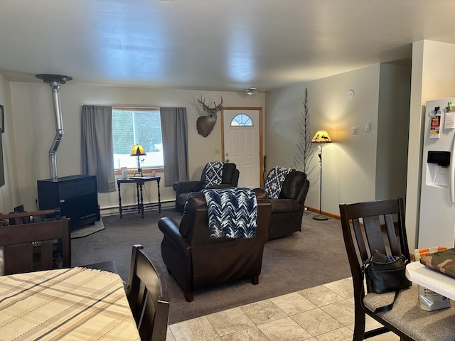 living room featuring baseboards, baseboard heating, and light colored carpet