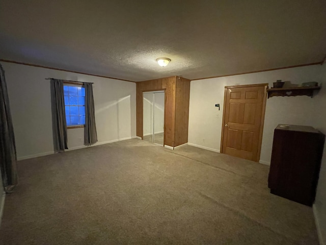 unfurnished room with carpet flooring and a textured ceiling