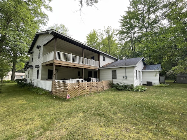 back of property with a lawn, a wooden deck, and cooling unit