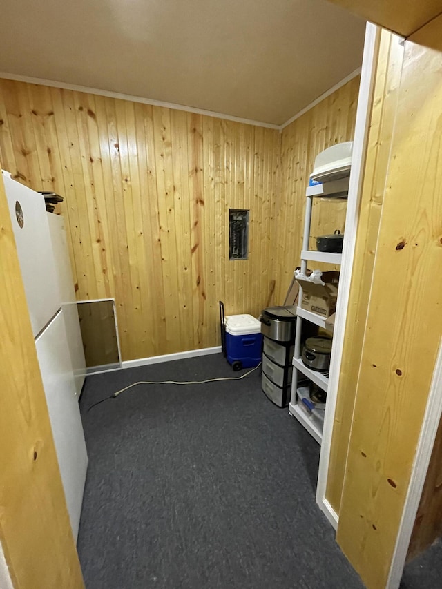 interior space with crown molding and wooden walls