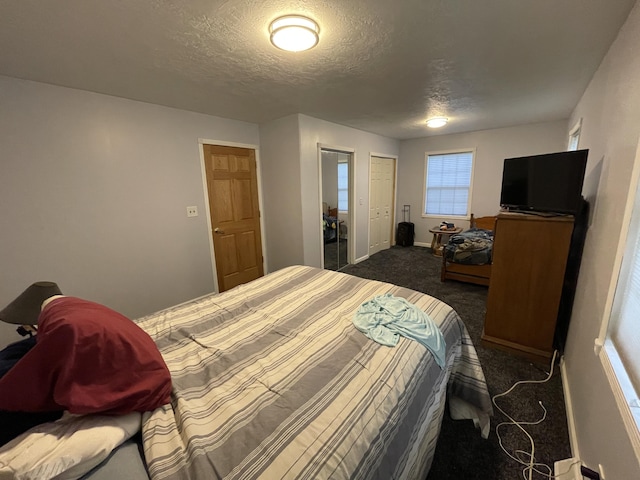 carpeted bedroom featuring a textured ceiling