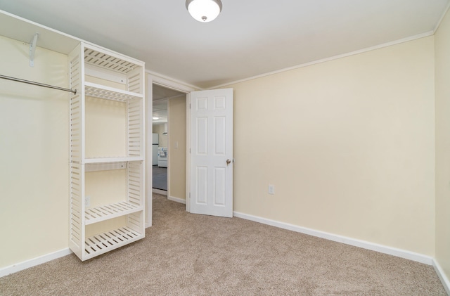 unfurnished bedroom featuring carpet, ornamental molding, and a closet