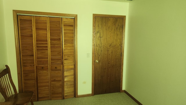 unfurnished bedroom featuring carpet and a closet