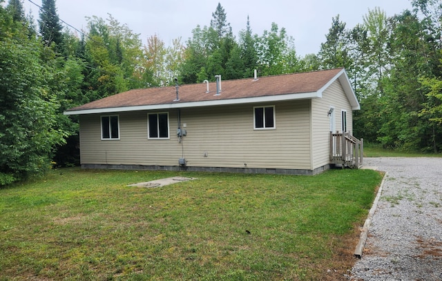 rear view of property with a lawn