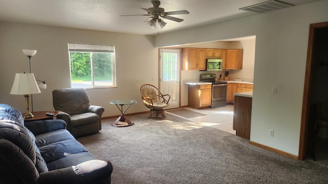 carpeted living room featuring ceiling fan