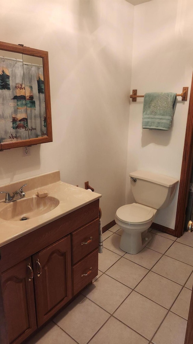 bathroom with vanity, toilet, and tile patterned flooring