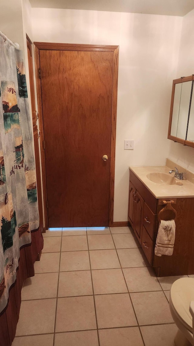 bathroom featuring vanity, toilet, and tile patterned floors