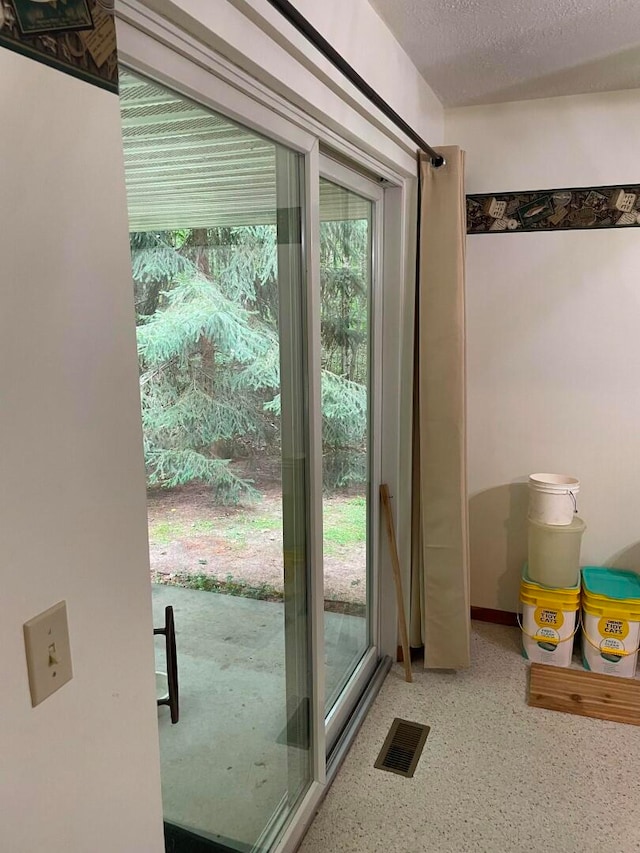 doorway featuring a textured ceiling