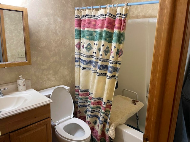 full bathroom featuring vanity, toilet, and shower / bath combination with curtain