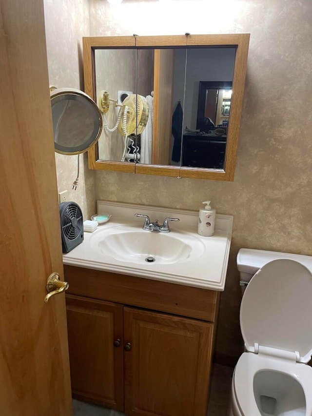 bathroom featuring vanity and toilet