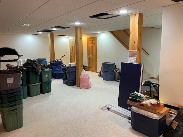 basement featuring carpet and a drop ceiling